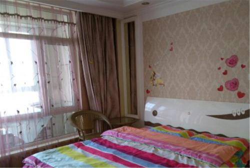 Imagen de la habitación del Dalian Jinshibandao Apartment Hotel. Foto 5