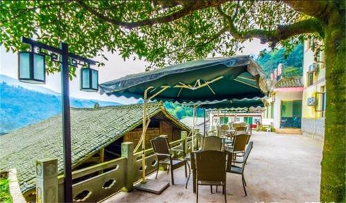 Imagen general del Emeishan Sanyuan Shuzhuang Home Stay. Foto 2