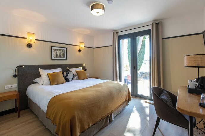 Imagen de la habitación del Les Villas du Château de Lastours. Foto 16