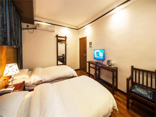 Imagen de la habitación del Zhangjiajie Yijia Inn. Foto 4