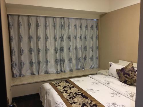 Imagen de la habitación del Zixinju Aparthotel. Foto 7