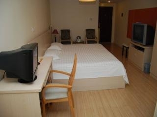 Imagen de la habitación del Apartahotel Central Dalian. Foto 2