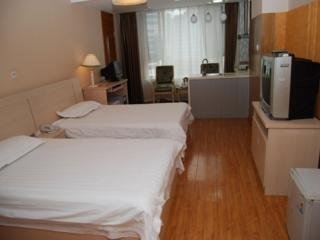 Imagen de la habitación del Apartahotel Central Dalian. Foto 3