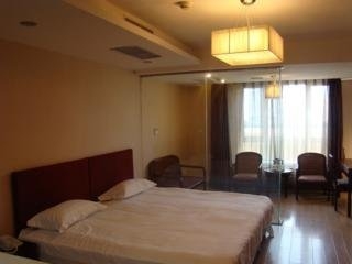Imagen de la habitación del Apartahotel Central Dalian. Foto 5