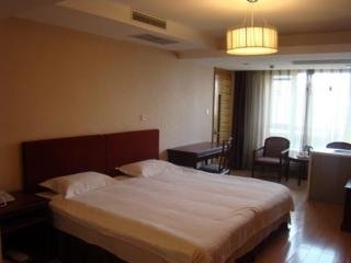 Imagen de la habitación del Apartahotel Central Dalian. Foto 6