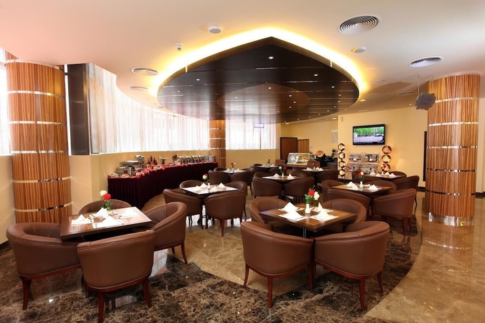 Imagen del bar/restaurante del Aparthotel Xclusive Maples Hotel Apartment. Foto 2