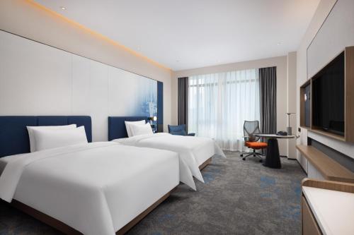 Imagen de la habitación del Hotel 广州新塘高铁站希尔顿欢朋酒店. Foto 17