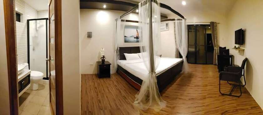 Imagen de la habitación del Hotel AandA Garden Suites. Foto 17