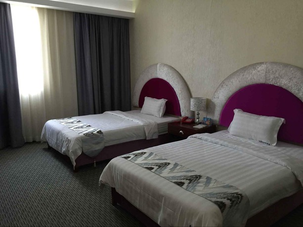 Imagen de la habitación del Hotel Aiqinhai. Foto 9
