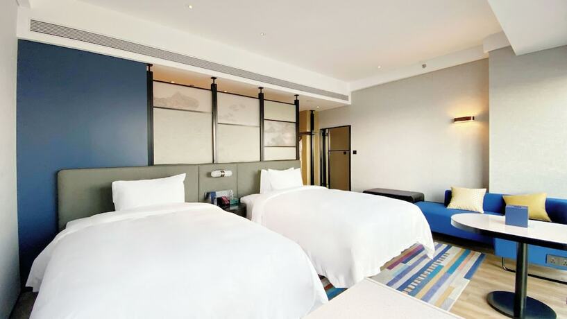 Imagen de la habitación del Hotel Aloft Yantai. Foto 22