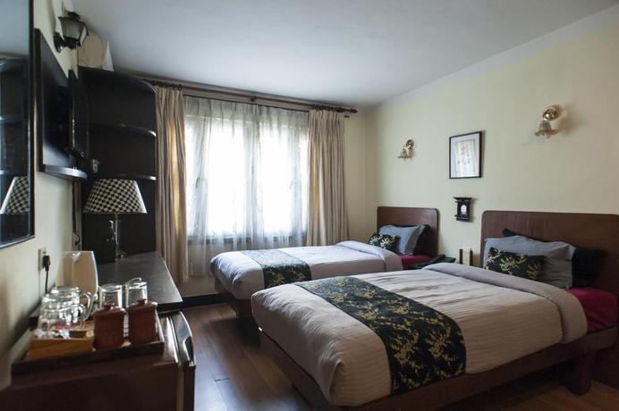 Imagen de la habitación del Hotel Ambassador Garden Home. Foto 12