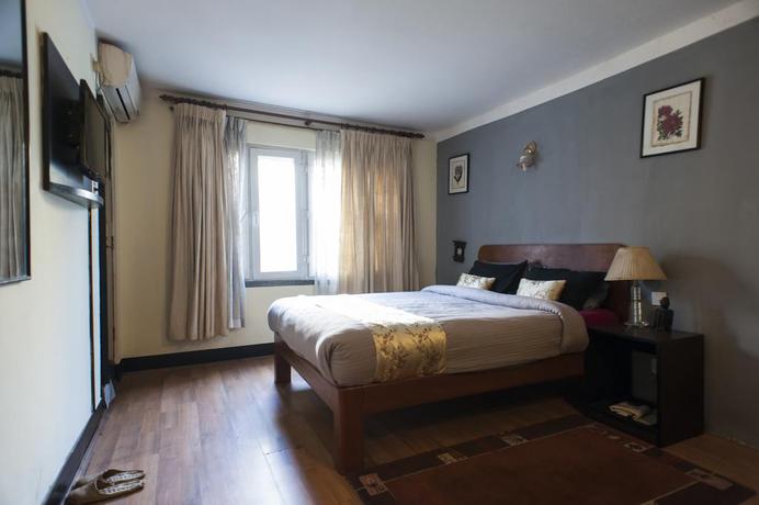 Imagen de la habitación del Hotel Ambassador Garden Home. Foto 13