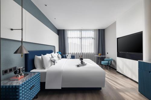 Imagen de la habitación del Hotel Anbo M Yiwu Wanda Plaza. Foto 17