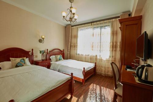 Imagen de la habitación del Hotel An'ji Dazhu Hailong Red Manor. Foto 9