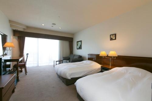 Imagen de la habitación del Hotel Aoyama Garden Resort Rosa Blanca. Foto 6
