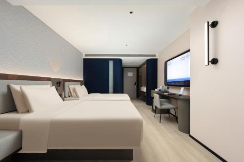 Imagen de la habitación del Hotel Atour Light Haikou Guomao Wanlv Garden. Foto 12