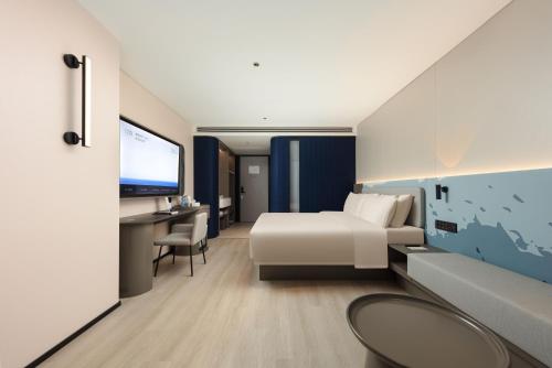 Imagen de la habitación del Hotel Atour Light Haikou Guomao Wanlv Garden. Foto 15