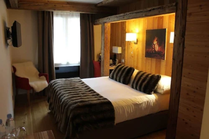 Imagen de la habitación del Hotel Au Coeur Du Village. Foto 4