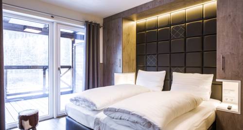 Imagen de la habitación del Hotel Avenida Mountain Lodges Saalbach. Foto 9