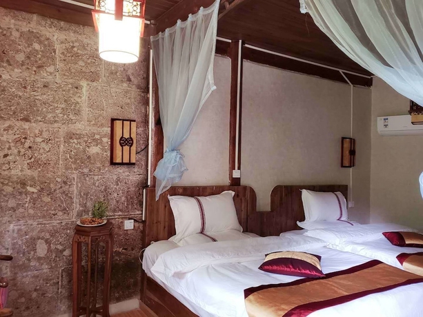 Imagen de la habitación del Hotel Baisha Holiday Resort Lijiang. Foto 3