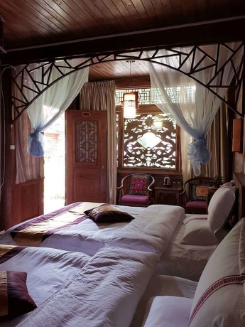 Imagen de la habitación del Hotel Baisha Holiday Resort Lijiang. Foto 4