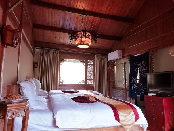 Imagen de la habitación del Hotel Baisha Holiday Resort Lijiang. Foto 6