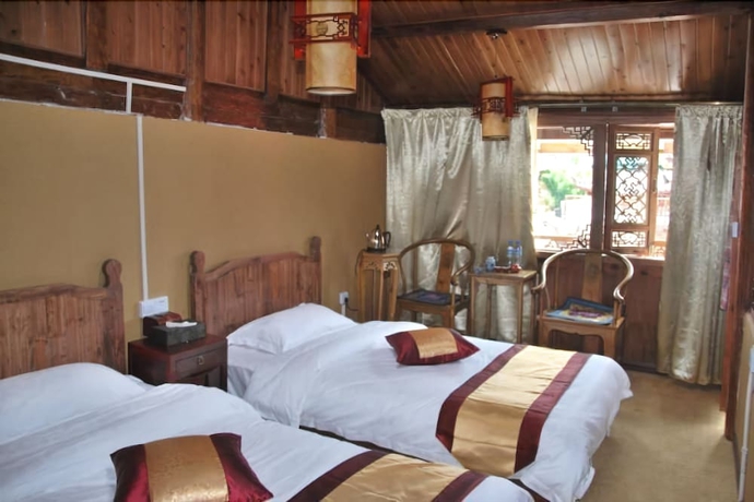 Imagen de la habitación del Hotel Baisha Holiday Resort Lijiang. Foto 7