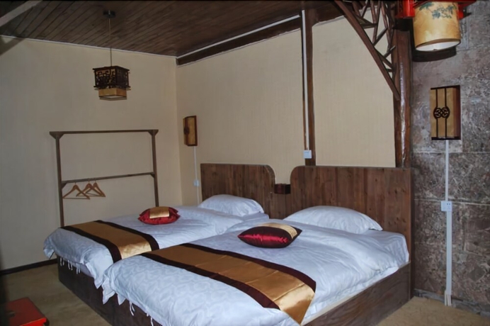 Imagen de la habitación del Hotel Baisha Holiday Resort Lijiang. Foto 8