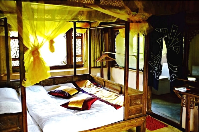 Imagen de la habitación del Hotel Baisha Holiday Resort Lijiang. Foto 9