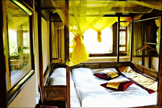 Imagen de la habitación del Hotel Baisha Holiday Resort Lijiang. Foto 10