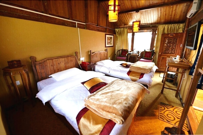 Imagen de la habitación del Hotel Baisha Holiday Resort Lijiang. Foto 11