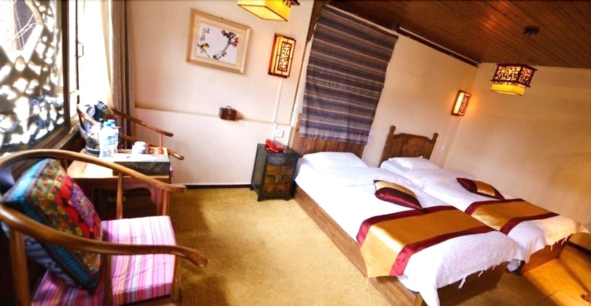Imagen de la habitación del Hotel Baisha Holiday Resort Lijiang. Foto 13
