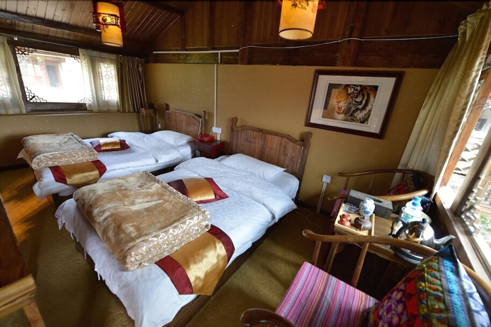 Imagen de la habitación del Hotel Baisha Holiday Resort Lijiang. Foto 14
