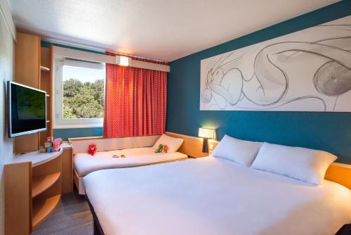 Imagen de la habitación del Hotel B&B Orléans Nord Saran. Foto 18