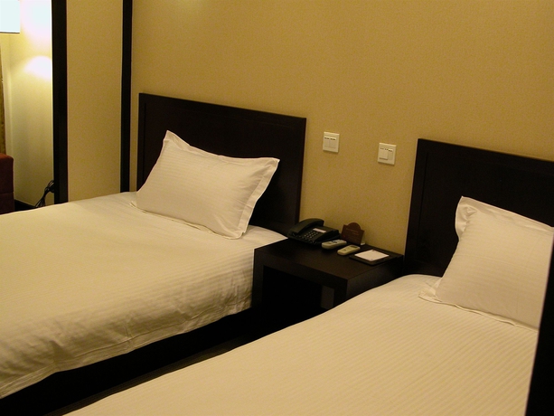 Imagen de la habitación del Hotel Baolong Homelike Wu Song Shanghai. Foto 3