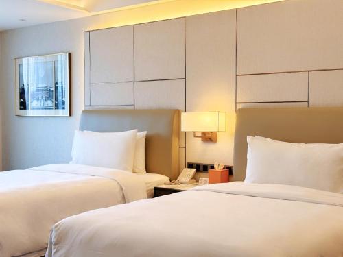 Imagen de la habitación del Hotel Beijing Xiamenair Jianianhua. Foto 8