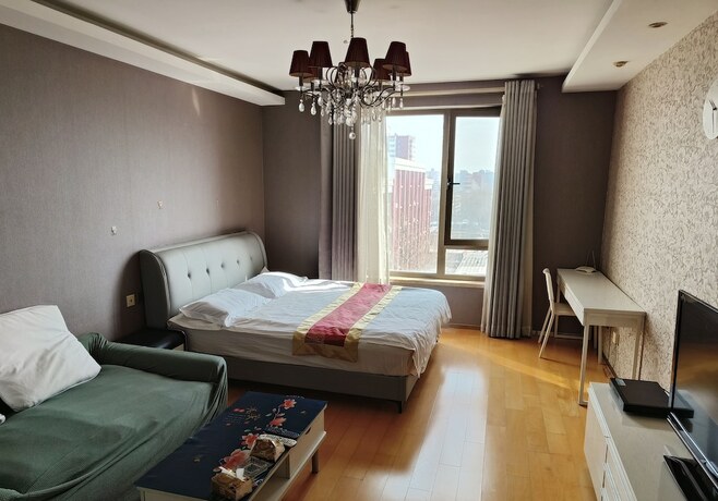Imagen de la habitación del Hotel Beijing Yilejia Apartment. Foto 12