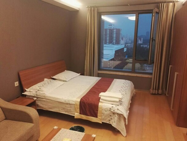 Imagen de la habitación del Hotel Beijing Yilejia Apartment. Foto 13