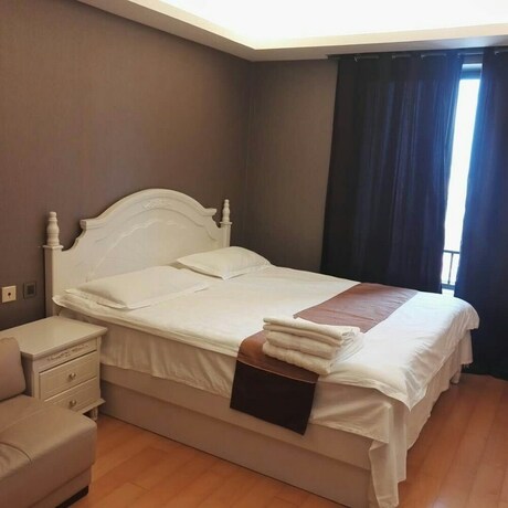Imagen de la habitación del Hotel Beijing Yilejia Apartment. Foto 14