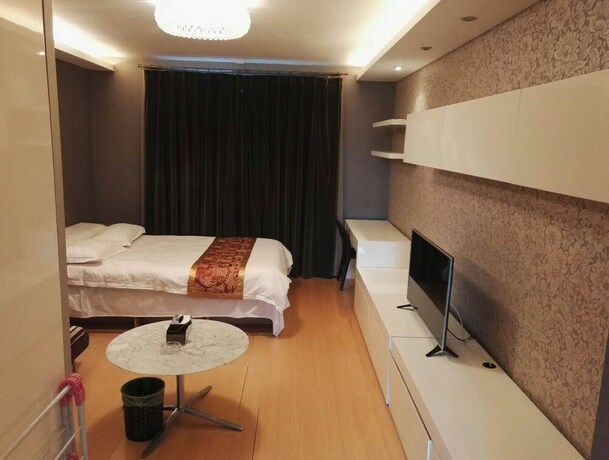 Imagen de la habitación del Hotel Beijing Yilejia Apartment. Foto 15