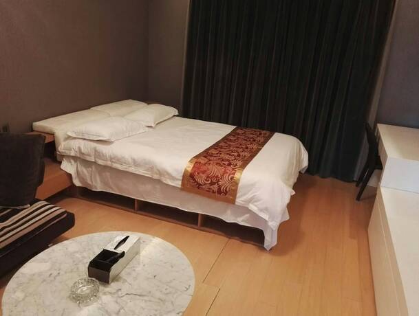 Imagen de la habitación del Hotel Beijing Yilejia Apartment. Foto 16