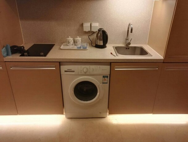 Imagen de la habitación del Hotel Beijing Yilejia Apartment. Foto 17
