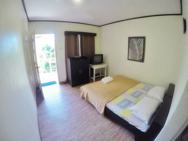 Imagen de la habitación del Hotel Blue Wave Inn Beach Resort and Restaurant. Foto 13