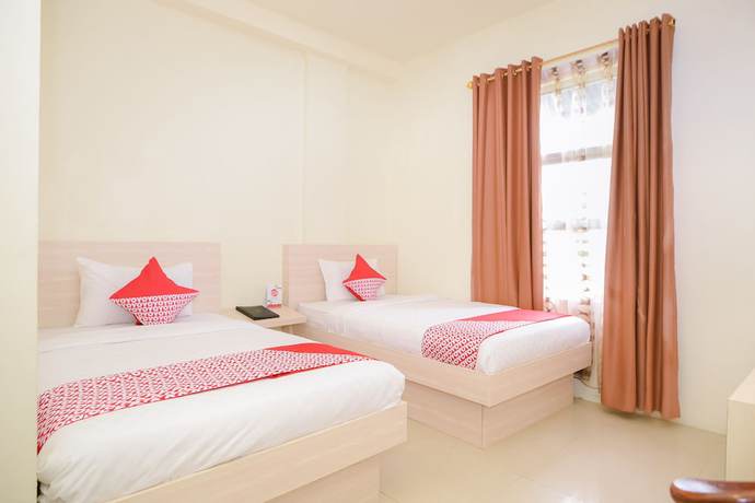 Imagen de la habitación del Hotel Capital O 854 Ub Caisar. Foto 5