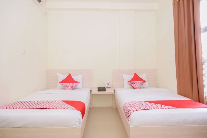 Imagen de la habitación del Hotel Capital O 854 Ub Caisar. Foto 8