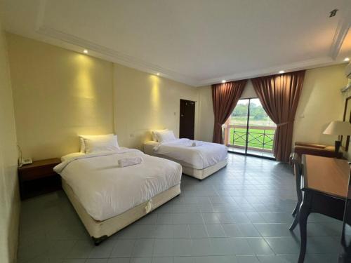 Imagen de la habitación del Hotel Capital O 91096 Usas Resort. Foto 17