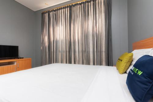 Imagen de la habitación del Hotel Capital O 91140 Ayodya Kebon Jeruk, Yakarta. Foto 19