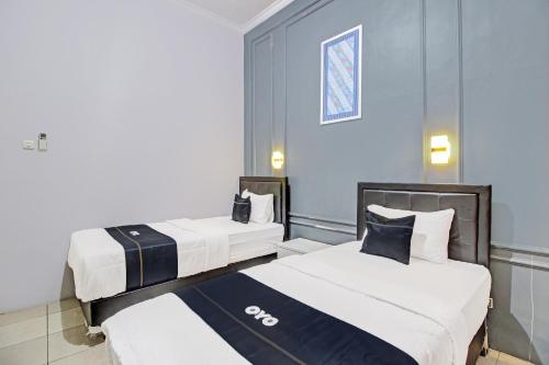 Imagen de la habitación del Hotel Capital O 92250 Hall & Guesthouse Kowapi Syariah. Foto 17