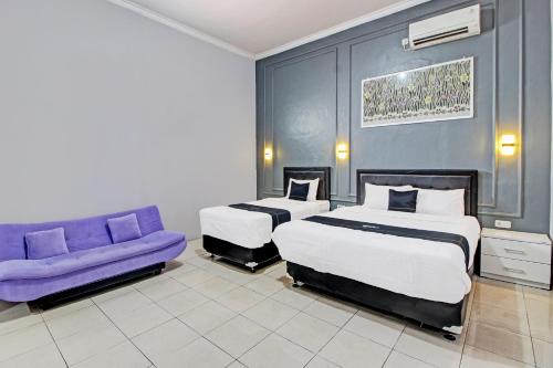 Imagen de la habitación del Hotel Capital O 92250 Hall & Guesthouse Kowapi Syariah. Foto 19
