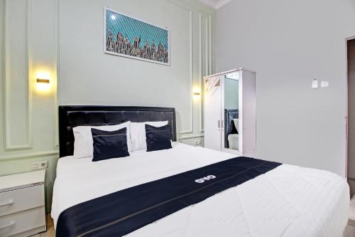 Imagen de la habitación del Hotel Capital O 92250 Hall & Guesthouse Kowapi Syariah. Foto 20